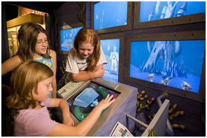 three girls at an aquarium
