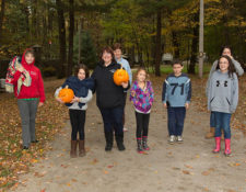 campers holding pumpkins at halloween